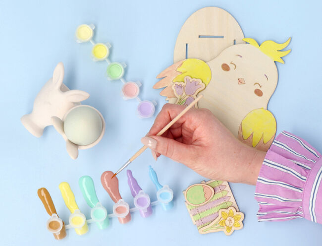 person painting easter bird cutout